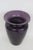 This is a charming small ceramic vase presents a two-toned design with a regal deep purple exterior and lighter purple...