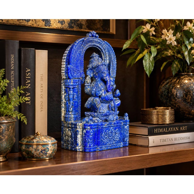This exceptional, intricately hand-carved sculpture depicts Lord Ganesha, sculpted from solid premium grade, natural deep-...