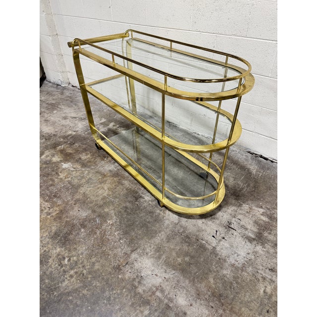 This is a great bar cart but has patina throughout its frame. Couple of chips on glass shelves at the corners, so not too...