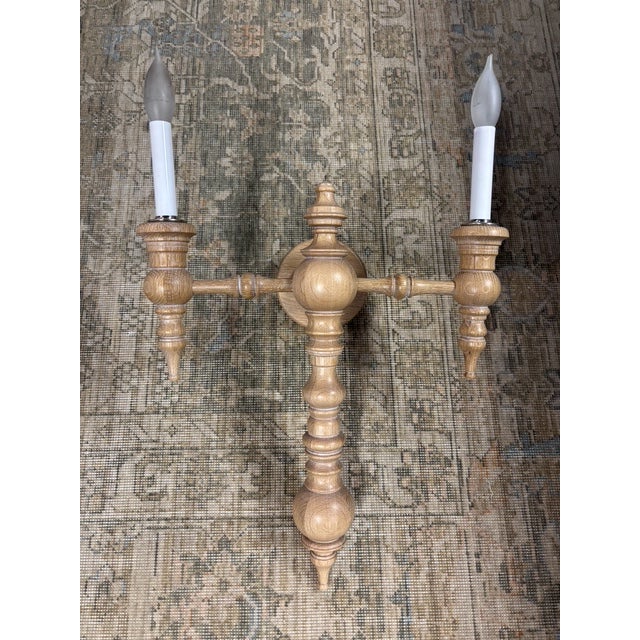 The Double Rachel Wall Sconce by Dunes & Duchess is a beautifully crafted turned wood sconce that brings timeless charm...
