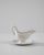 A vintage porcelain sauce boat made in Belgium, circa 1900. White china is finished with a luscious glossy glaze,...