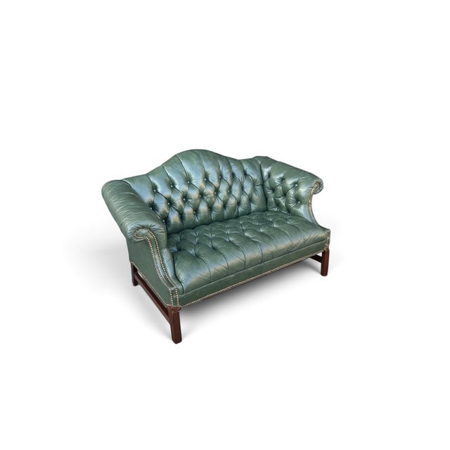 This vintage camelback settee combines Chippendale-inspired details with the classic character of Chesterfield design....