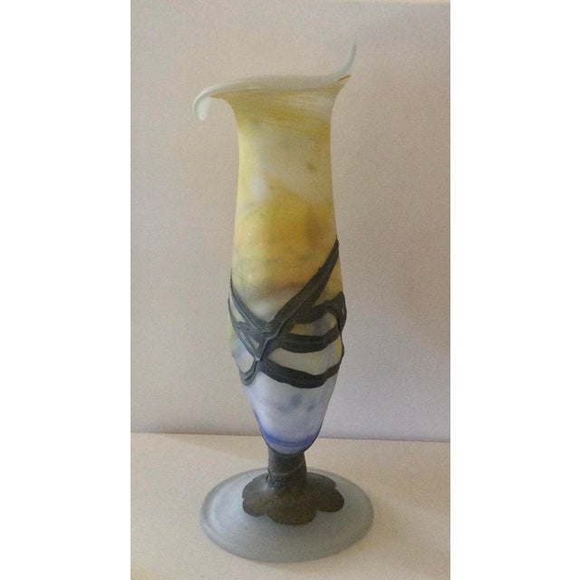 A luminous, hand-blown glass vase, part of the prestige range, featuring copper, nickel, and brass applied using...