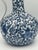 A beautifully hand painted blue and white chinoiserie porcelain ewer featuring a graceful curved handle, bulbous body, and...