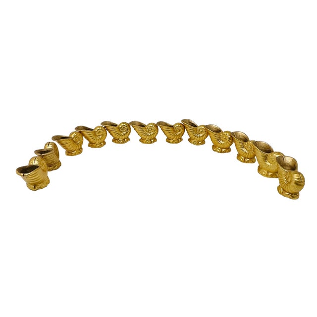 Elevate your next tablescape with this stunning, complete set of 12 vintage nautilus shell place card holders. Finished in...