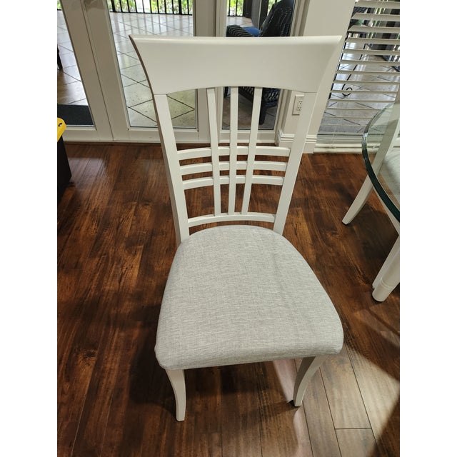 Thomasville furniture collection featuring a round glass top and a painted white wooden base with matching chairs. Heavy...