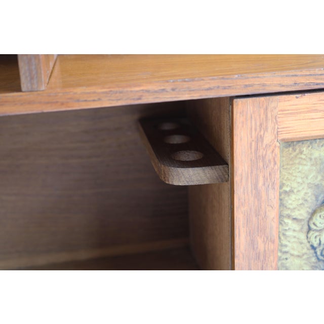 Lovely English Arts & crafts wall cabinet with brass panels displaying Shakespeare made from oak. The cabinet has many...