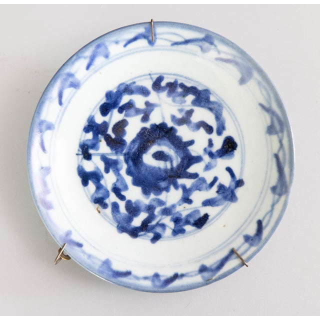 A lovely pair of diminutive antique Chinese plates in traditional blue and white colors, custom hangers attached.