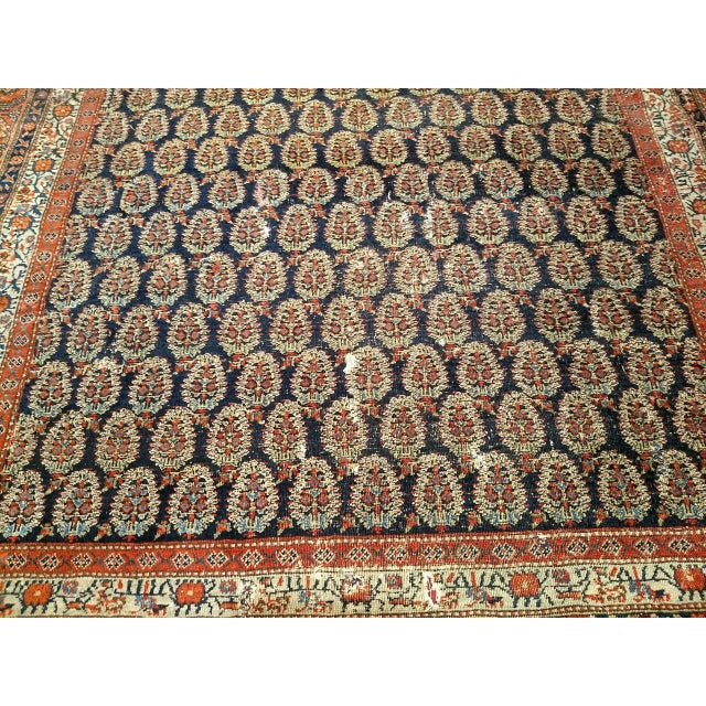 A Persian Farahan in an allover paisley design set in a dark blue field with a cream color main border. A masterpiece of...