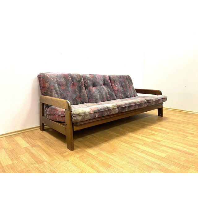 A stylish retro sofa produced in the second half of the 20th century, featuring a solid wooden frame, removable...
