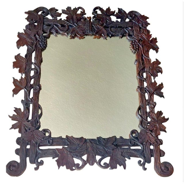 Antique mirror, beautiful wood carving of oak leaves, Black Forest. The mirror work is completely intact. A beautiful and...