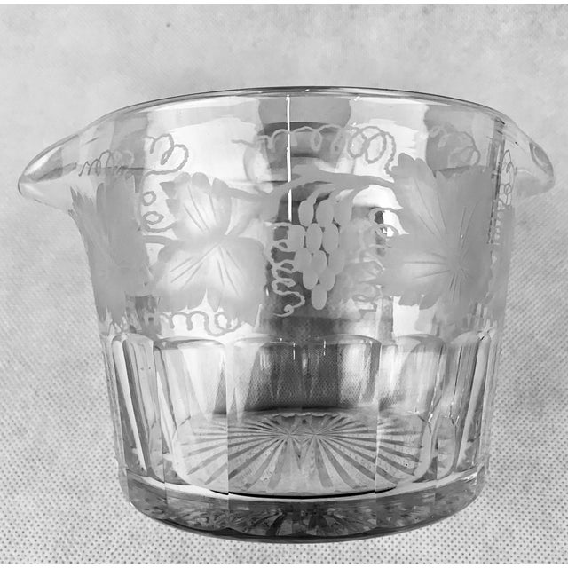 Victorian engraved and cut glass double lipped wine rinser with a pattern of grapes and leaves. The bottom half of this...