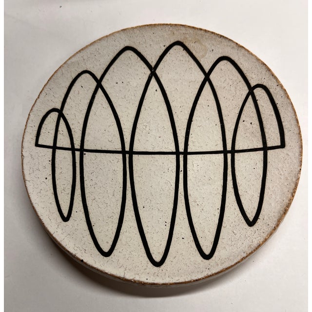 Wonderful white stoneware dish hand painted with black spiral. Bottom has Michele Quan initials and "Om" symbol incised in...