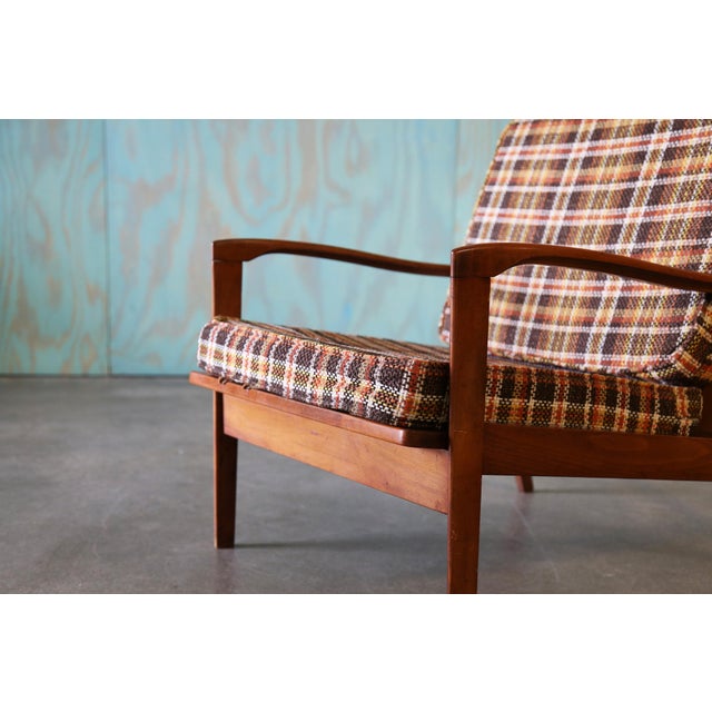 Nice profile with a slat wood back and plaid cushions. No markings present on the frame, likely made in yugoslovia after a...