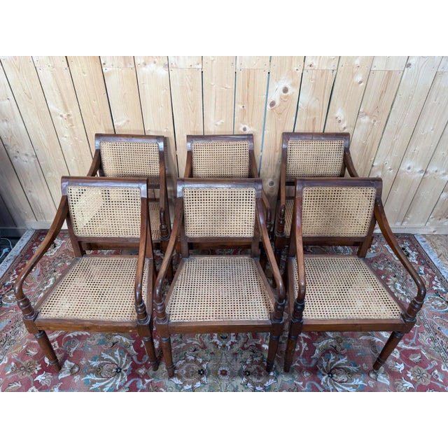 Set of six British-influenced colonial armchairs in solid wood, stained dark brown, dating from the late 19th century....