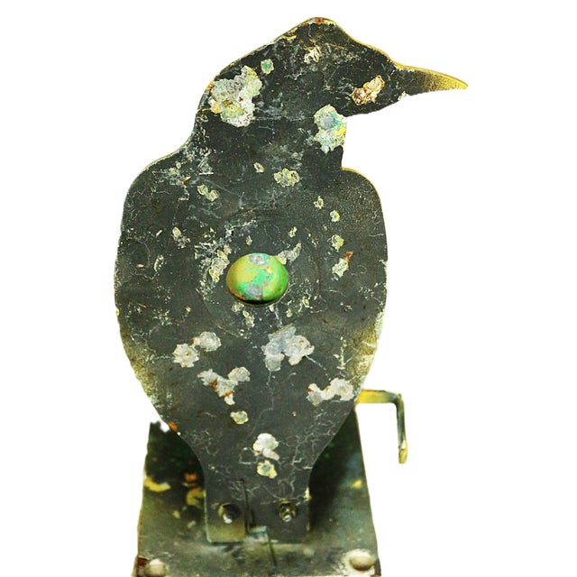 An early 20th century American shooting gallery target in the form of a black crow with several coats of old paint. The...