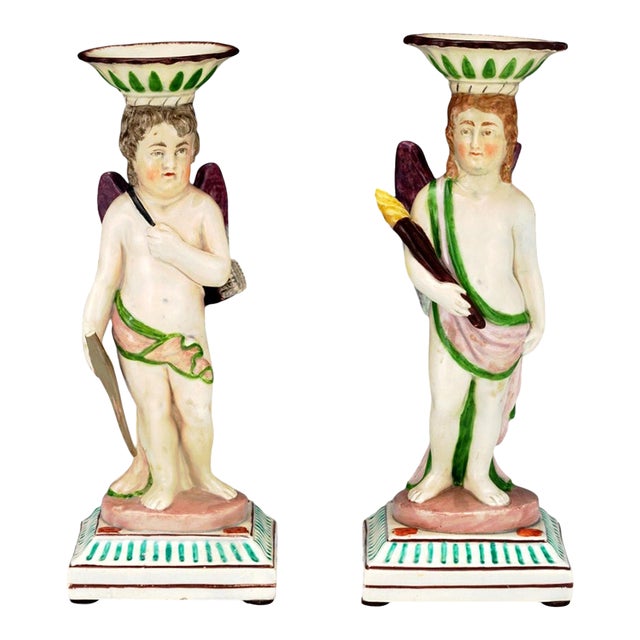 Pair of English Pearlware Cupid and Torchbearer Figural Candlesticks, Attributed to Neale & Co. Or Wilson For Sale