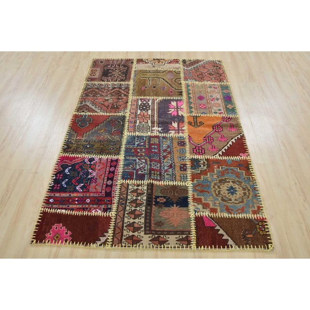 An authentic vintage patchwork rug, hand-knotted with wool and has a cotton backing. This oriental rug features pieces of...