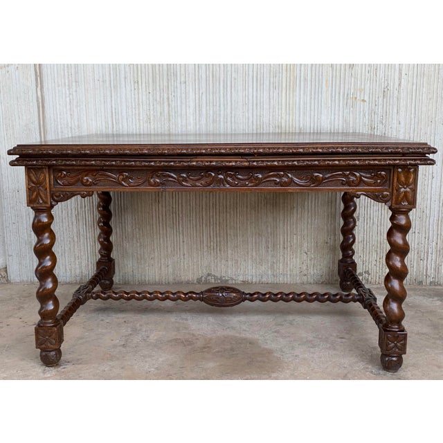 About Spanish colonial Baroque walnut turned legs extendable table with carved stretcher and two additional leafs,...