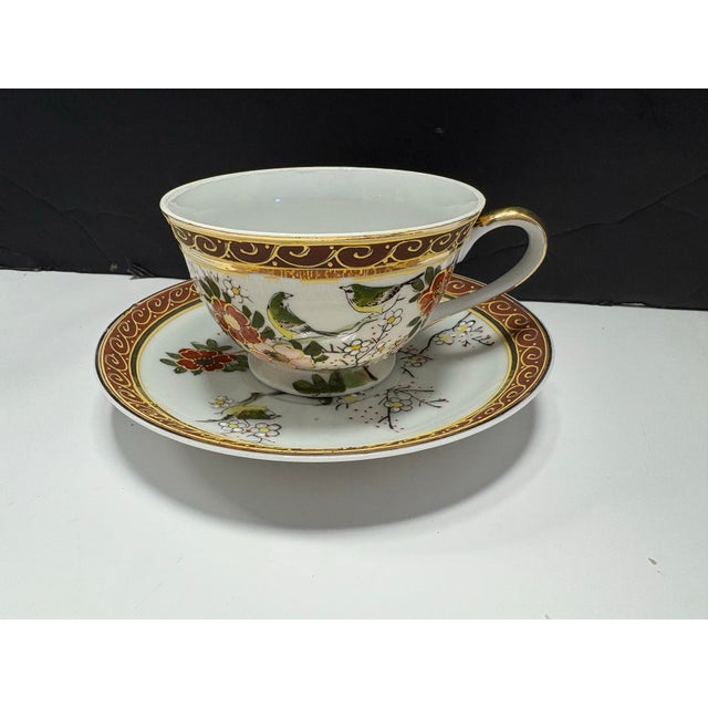 Stunning vintage Taiei Japan porcelain teacup and saucer set featuring a delicate bird and floral design with rich...