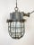 Industrial hanging lamp made in former Czechoslovakia during the 1960s. It features cast iron top, clear glass cover and...