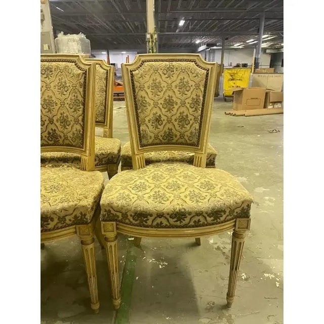 French provincial set of six dining chairs made in the style of French Louis XVI/ Marie Antoinette. The chairs feature a...