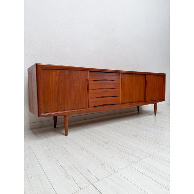 Elegant danish sideboard designed by axel christensen for aco møbler during the 1960s. Crafted in teak, the piece features...
