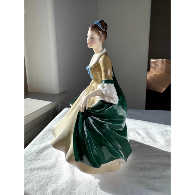 “Elegance” (H.N. 2264), introduced by Royal Doulton in 1956, is a finely modeled bone china figurine from the...
