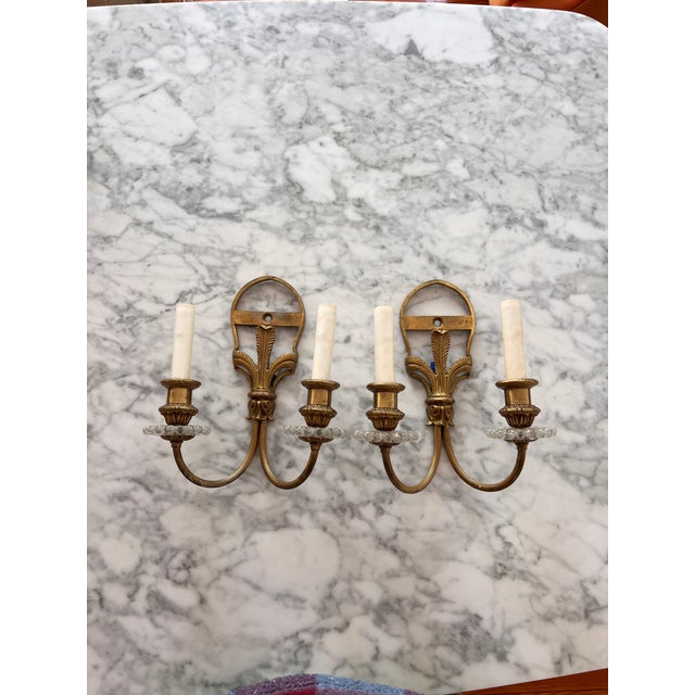Louis XIV Style Two-Arm brass and glass sconces Pair of two The sheaf of feathers ornamenting the classic shape of the...