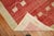 An abstract midcentury Turkish Anatolian rug with a brick red field with accents in green and pink. Size: 4'6” x 7'2”...