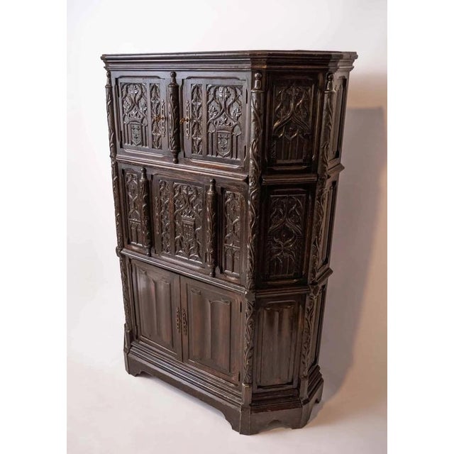 Antique solid oak cabinet decorated with rich carvings in the Gothic style. The cabinet is sturdy and in excellent...