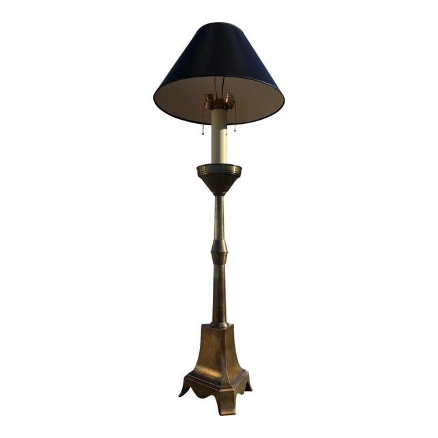 A rare and massive brass candlestick floor lamp featuring, dual bulbs, brass pull strings, in the manner of Mastercraft,...