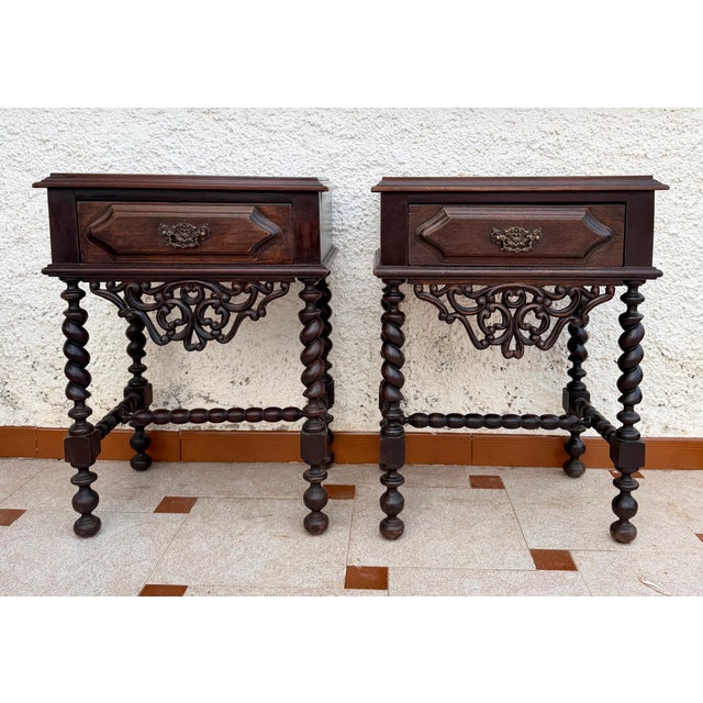 Elegant pair of Portuguese bedside tables dating from the 1940s, featuring a practical drawer with its original decorative...