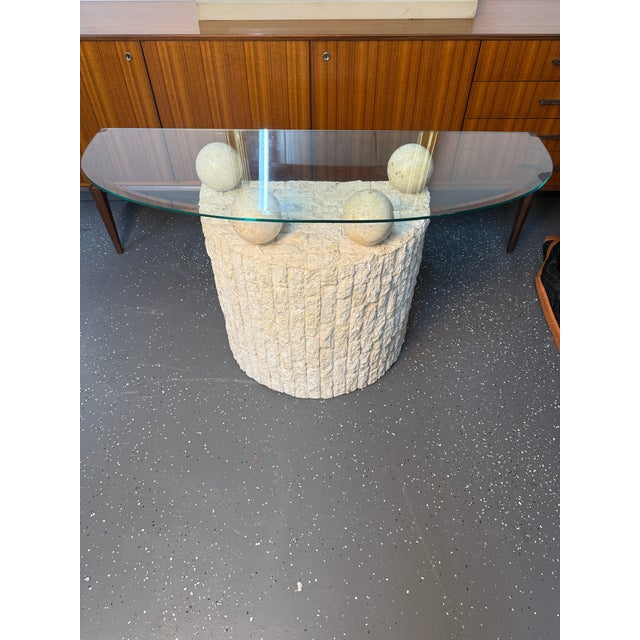 1990’s post-modern demi-lune tessellated stone table with glass top. Beveled glass top rests on four travertine stone...