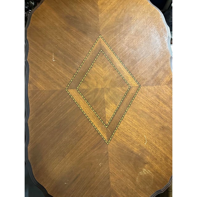 Antique carved walnut occasional accent table. It is made of carved walnut wood and features intricate carvings and...