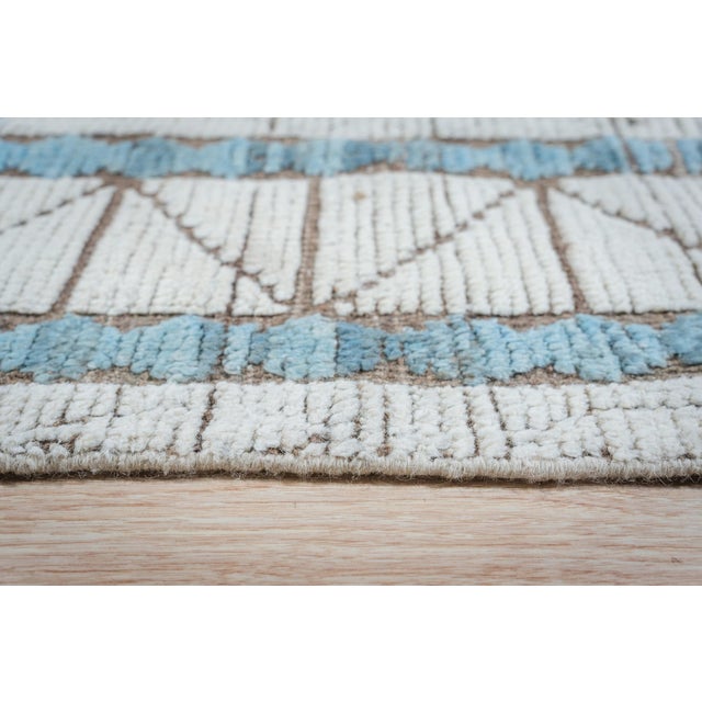 Timeless Marrakech Ivory Hand-Knotted Wool Berber Carpet, Country of Origin: Pakistan. This exceptional piece captures the...