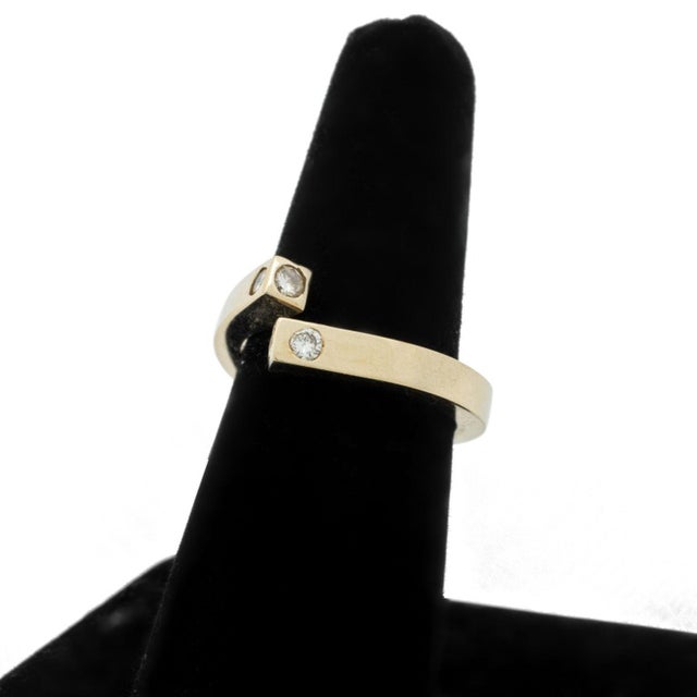 Modernist Diamond and 14K Yellow Gold Ring, adorned with 4 round diamonds weighing a total of approx. 0.20 carat, marked:...