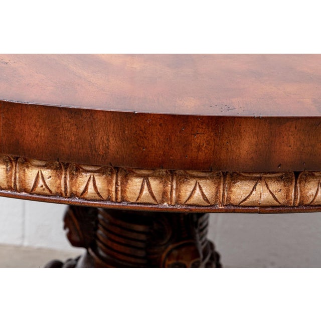 A vintage Renaissance Revival style mahogany center hall or breakfast table with a gadrooned carved edge apron, richly...