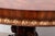 A vintage Renaissance Revival style mahogany center hall or breakfast table with a gadrooned carved edge apron, richly...