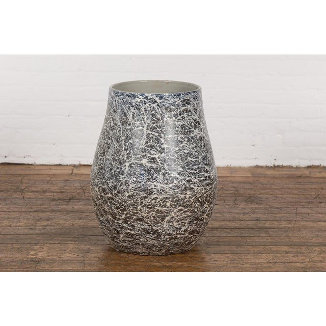An artisan Prem Collection ceramic planter with nice rounded shape, black ground, white and grey blue splatter and grey...