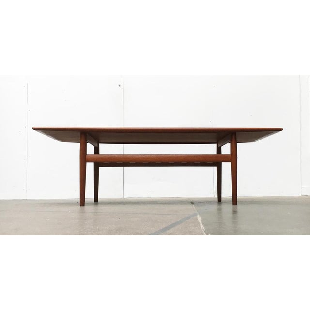 Danish teak coffee table from Glostrup designed by Grete Jalk. The special feature of this table is the elegantly curved...