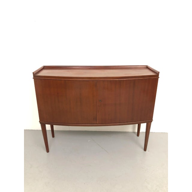 Refined mahogany sideboard with a warm, intense reddish color, 1950s, designed by Vanzania, a renowned Italian company...