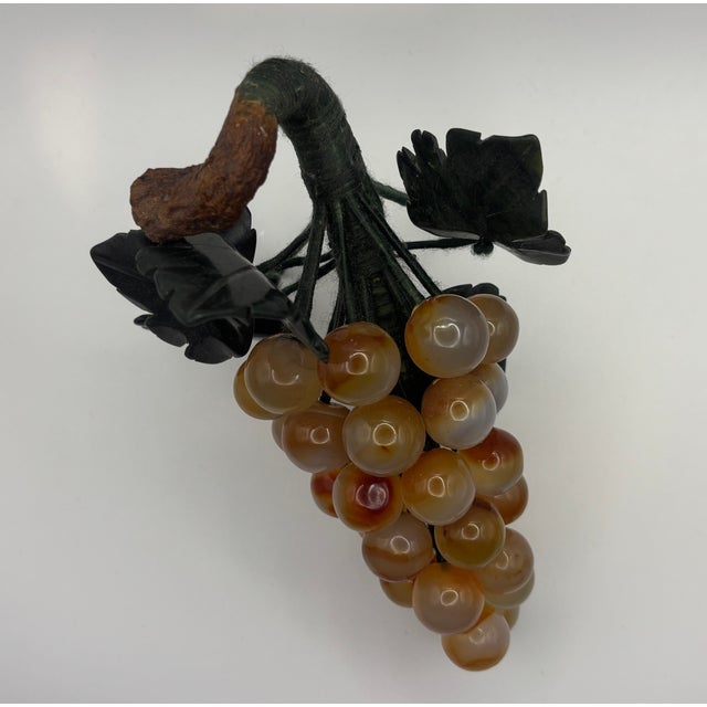 Vacation setting: 08/28/2025 to 09/23/2025 Vintage Jade Grape Cluster with Stone Leaves and Built-in Stand This piece...