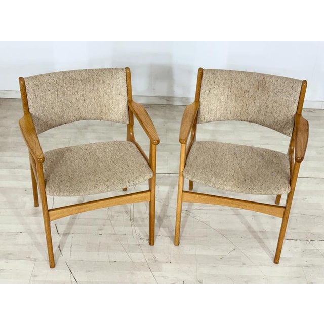 Exclusive pair of original Danish armchairs, designed by renowned designer Erik Buch in the 1960s. These chairs represent...