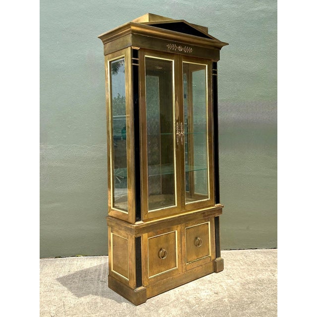 This magnificent brass vitrine by Mastercraft is a hallmark of 1970s Hollywood Regency opulence. Its commanding...