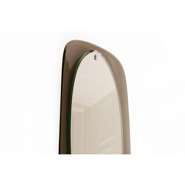 A sophisticated Italian wall mirror from the 1970s, showcasing the refined craftsmanship typical of Italian design of the...