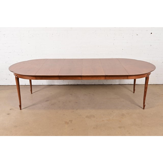 An exceptional mid-century modern Hollywood Regency extension dining table By Mastercraft USA, Circa 1960s Carved cherry...