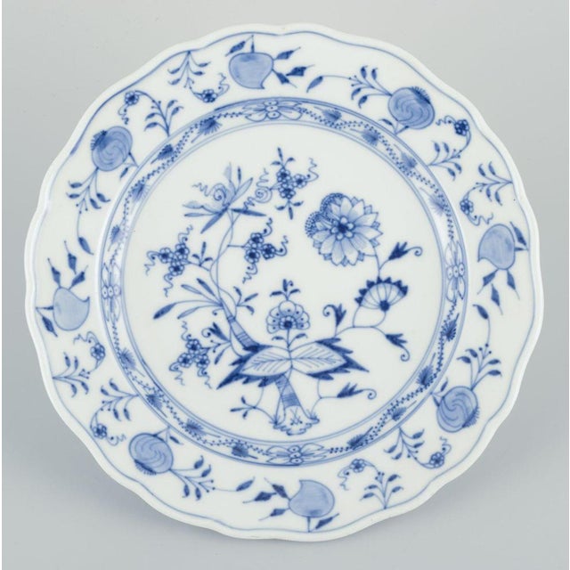 Meissen, Germany. A set of four Blue Onion patterned porcelain plates. Hand painted. Early 1900s. Marked. Two plates in...