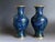 This elegant pair of mid-20th-century Chinese cloisonné vases features traditional floral motifs rendered in vivid cobalt...