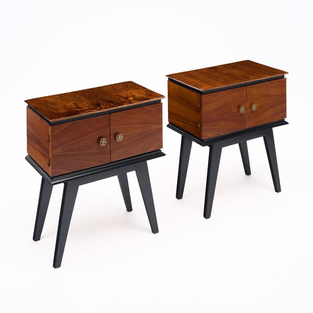 Pair of side tables from mid-century modern France. Each is made of solid wood construction with a flamed mahogany veneer....